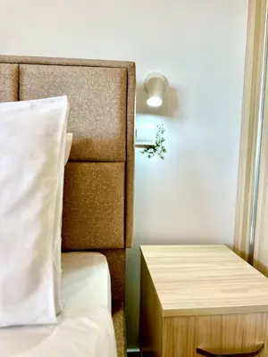 a bedroom with a bed and a nightstand next to a bed sidx sidx sidx at Central Napa Escape - Adults Only in Ayia Napa