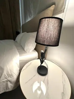 a lamp on a table next to a bed at Verasia Acute Stay in Engomi in Engomi