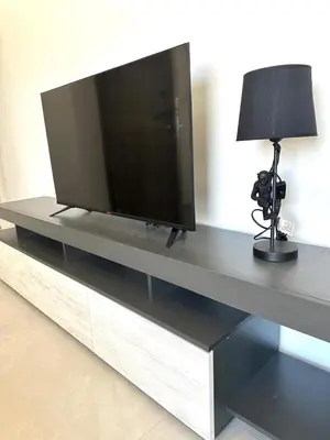 a flat screen tv sitting on a entertainment center at Verasia Acute Stay in Engomi in Engomi