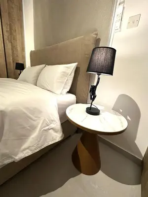 a bedroom with a bed and a table with a lamp at Verasia Acute Stay in Engomi in Engomi