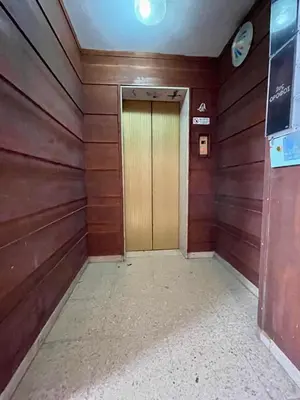 a door in a room with wooden walls at Centro Apartment Larnaca in Larnaka