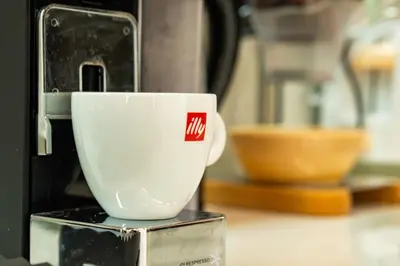 a coffee cup sitting on top of a coffee machine at SuiteNapa22 in Ayia Napa