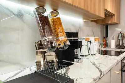 a kitchen counter with a rack of food at SuiteNapa22 in Ayia Napa