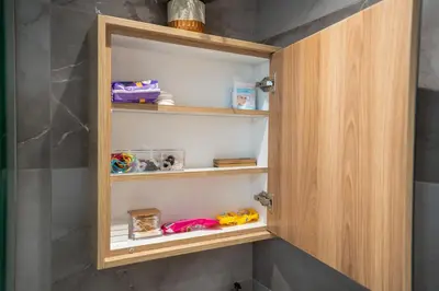 a closet with wooden shelves in a bathroom at SuiteNapa22 in Ayia Napa