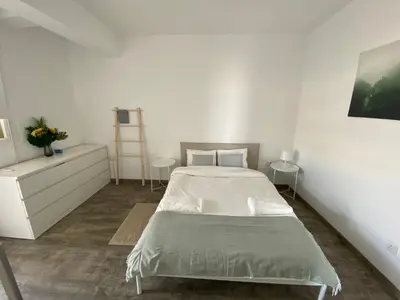 a white bedroom with a bed and a dresser at Luxurious Penthouse in Larnaca Center 300m From The Beach in Larnaka