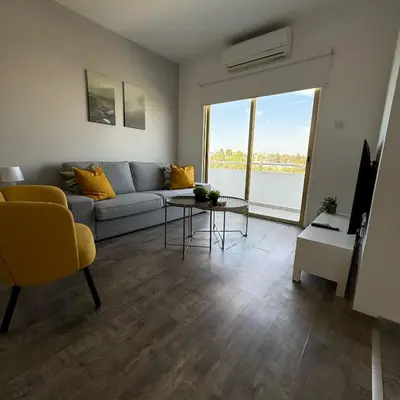 a living room with a couch and a table at Luxurious Penthouse in Larnaca Center 300m From The Beach in Larnaka