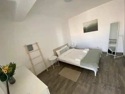 a white room with a bed and a table at Luxurious Penthouse in Larnaca Center 300m From The Beach in Larnaka