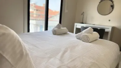 a white bed with two pillows on top of it at City Centre 2-Bedroom, Old Town, Nicosia in Nicosia