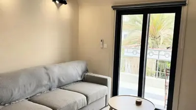 a living room with a couch and a table and a window at City Centre 2-Bedroom, Old Town, Nicosia in Nicosia