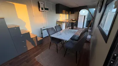 a small kitchen with a table and chairs in a room at Garden Cottage Cyprus in Ayia Napa