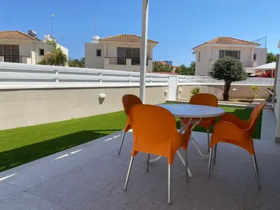 a table and chairs sitting on a patio at Mimosa 18 Beachhouse Villa in Protaras