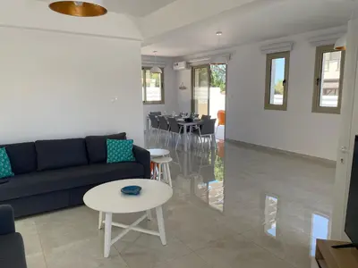 a living room with a couch and a table at Mimosa 18 Beachhouse Villa in Protaras
