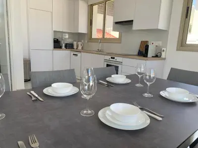 a dining room table with plates and wine glasses at Mimosa 18 Beachhouse Villa in Protaras