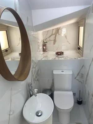 a bathroom with a white toilet and a mirror at Mimosa 18 Beachhouse Villa in Protaras