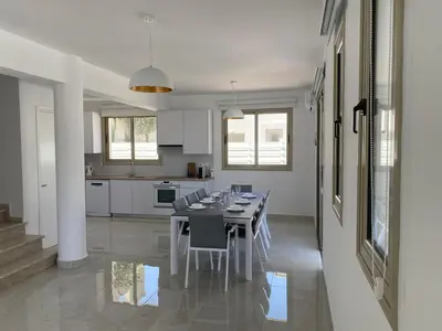 a dining room and kitchen with a table and chairs at Mimosa 18 Beachhouse Villa in Protaras