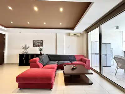 a living room with a red couch and a table at STAY Mesa Luxe Apartment in Limassol