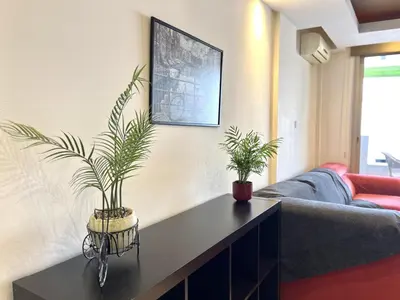 a living room with two potted plants on a table at STAY Mesa Luxe Apartment in Limassol