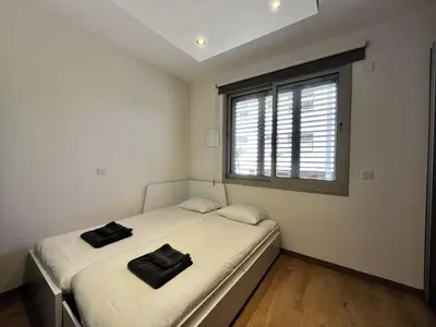 two beds in a room with a window at STAY Mesa Luxe Apartment in Limassol
