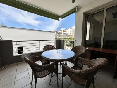 a patio with a table and chairs on a balcony at STAY Mesa Luxe Apartment in Limassol