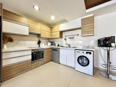 a kitchen with a washing machine and a washer at STAY Mesa Luxe Apartment in Limassol