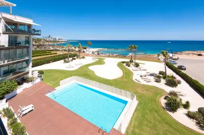 an aerial view of a resort with a swimming pool and the ocean at Apartment Marina - Beachfront in Protaras