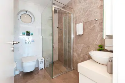 a bathroom with a shower and a toilet and a sink at Apartment Marina - Beachfront in Protaras
