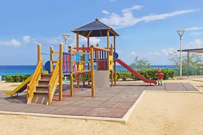 a playground on the beach with a slide at Apartment Marina - Beachfront in Protaras