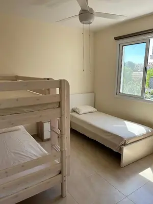a bedroom with two bunk beds and a window at Cozy 2-Bedroom Beach Flat in Paralimni