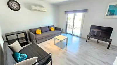 a living room with a couch and a table at Molos city centre living in Limassol