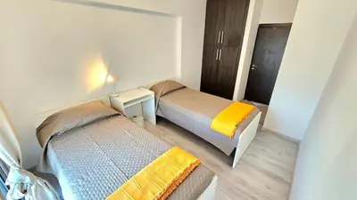 two beds in a small room with a bedsenalsenalsenalsenalsenalsenalsenal at Molos city centre living in Limassol