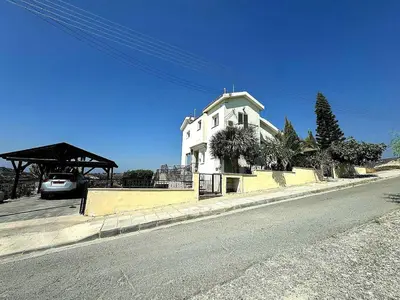 a white house on the side of a street at Serenity Pool & Garden Villa in Limassol