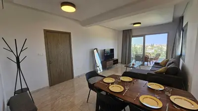 a living room with a wooden table and a living room with a couch at Suburban Escape in Limassol