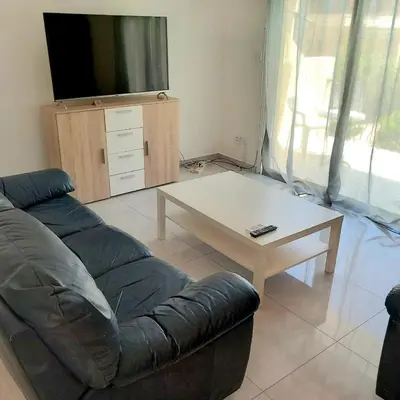 a living room with a couch and a coffee table at Cydonia Gardens Maisonette with shared pool in Limassol