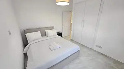 a bedroom with a large white bed with two pillows at Sea Breeze 3 Bed Frontline Flat in Limassol