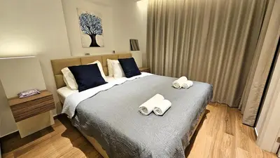 a bedroom with a bed with two towels on it at The Suave - Limassol City Centre Luxury in Limassol