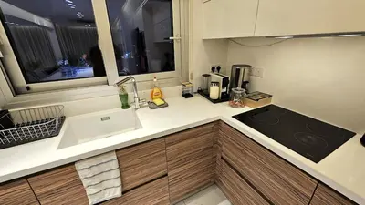 a kitchen counter with a sink and a window at The Suave - Limassol City Centre Luxury in Limassol