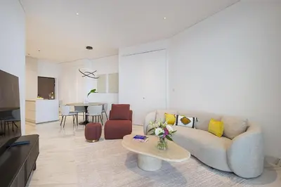 a living room with a couch and a table at Trilogy Limassol Seafront in Limassol