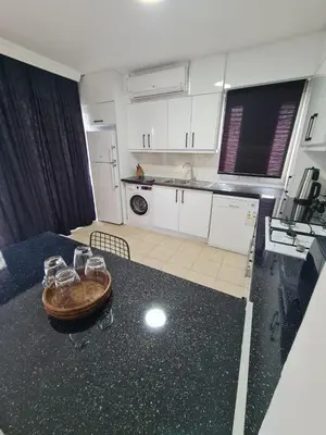 a kitchen with a table with wine glasses on it at At Patara Site, the heart of Kyrenia in Aglantzia
