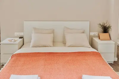 a bedroom with a large bed with two night stands at Geometry Park in Ayios Theodhoros