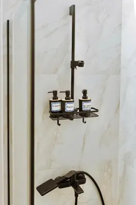 a wall mounted shelf with four bottles on it at Geometry Park in Ayios Theodhoros