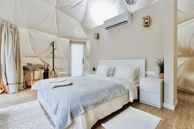 a white bedroom with a large bed in a room at Geometry Park in Ayios Theodhoros