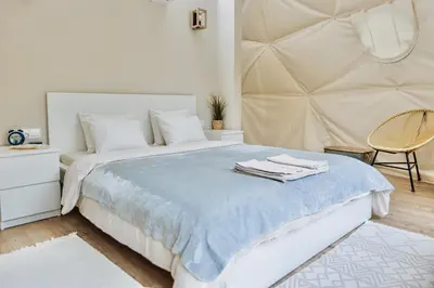 a bedroom with a large bed with towels on it at Geometry Park in Ayios Theodhoros