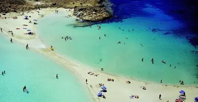 a group of people in the water at a beach at Cornelia Hotel Ayia Napa Center in Ayia Napa