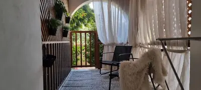 a teddy bear standing in a room with a balcony at Paradise Garden Sweet Studio in Limassol