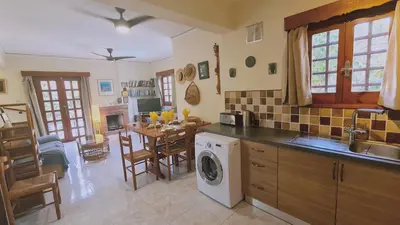a kitchen with a washing machine and a dining room at STAY Villa Michalis in Pissouri