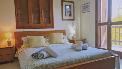 a bedroom with a bed with pillows on it at STAY Villa Michalis in Pissouri