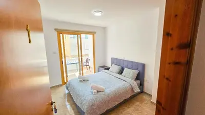 a bedroom with a bed with two stuffed animals on it at Central City Rooms in Larnaka