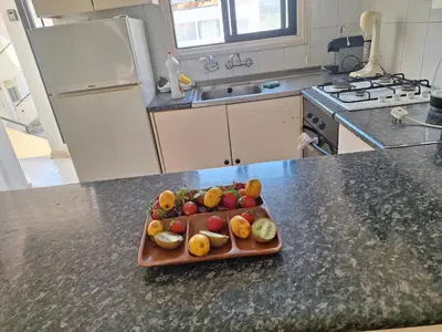 a tray of fruit on a counter in a kitchen at Easy 2 bedroom apartment, Makenzi beach in Larnaka