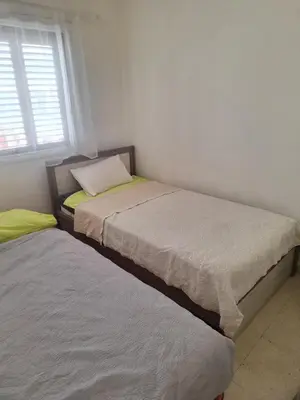 two twin beds in a room with a window at Easy 2 bedroom apartment, Makenzi beach in Larnaka