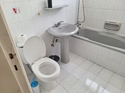 a bathroom with a toilet and a sink at Easy 2 bedroom apartment, Makenzi beach in Larnaka